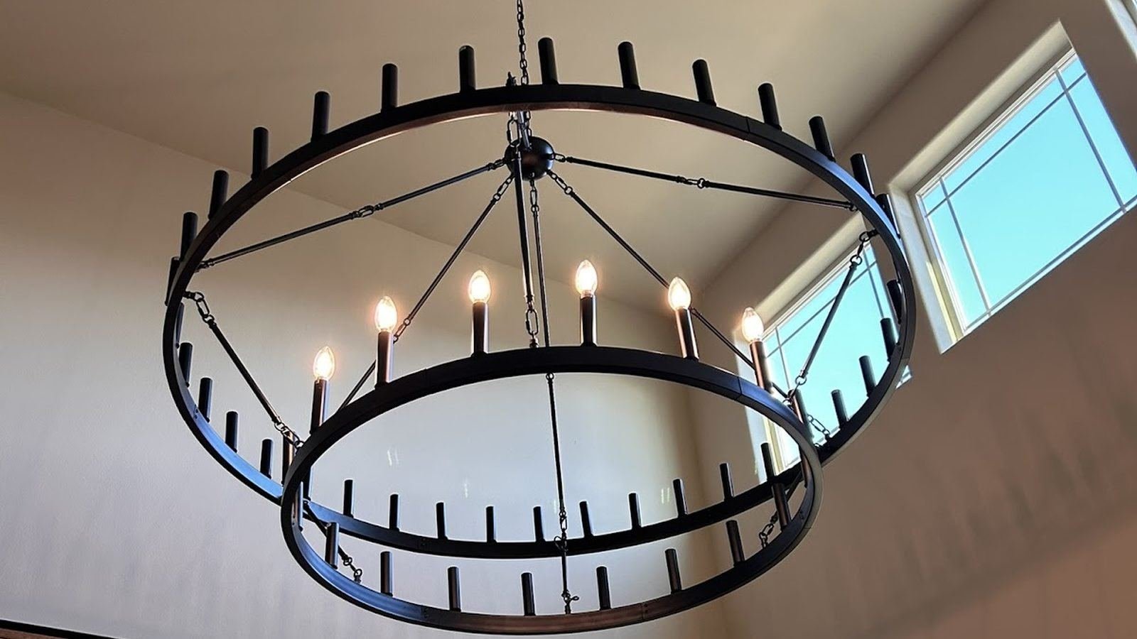 Two-tier ring chandelier hung on a vaulted ceiling