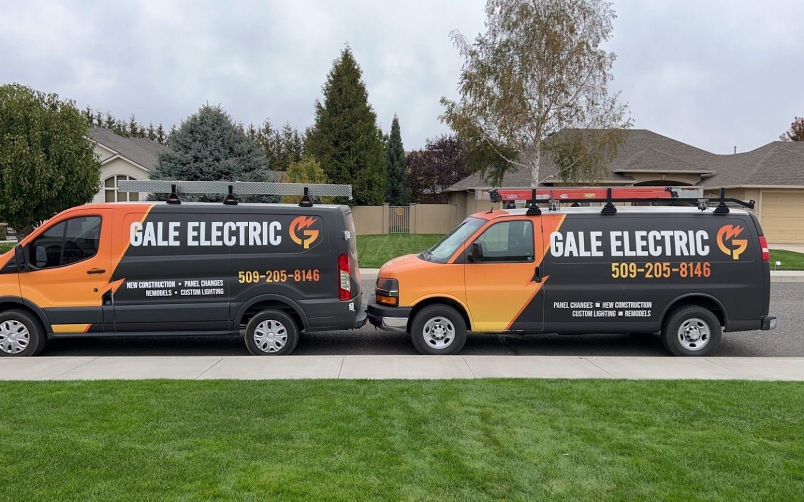 Two branded Gale Electric service vans parked at a Tri-Cities job
